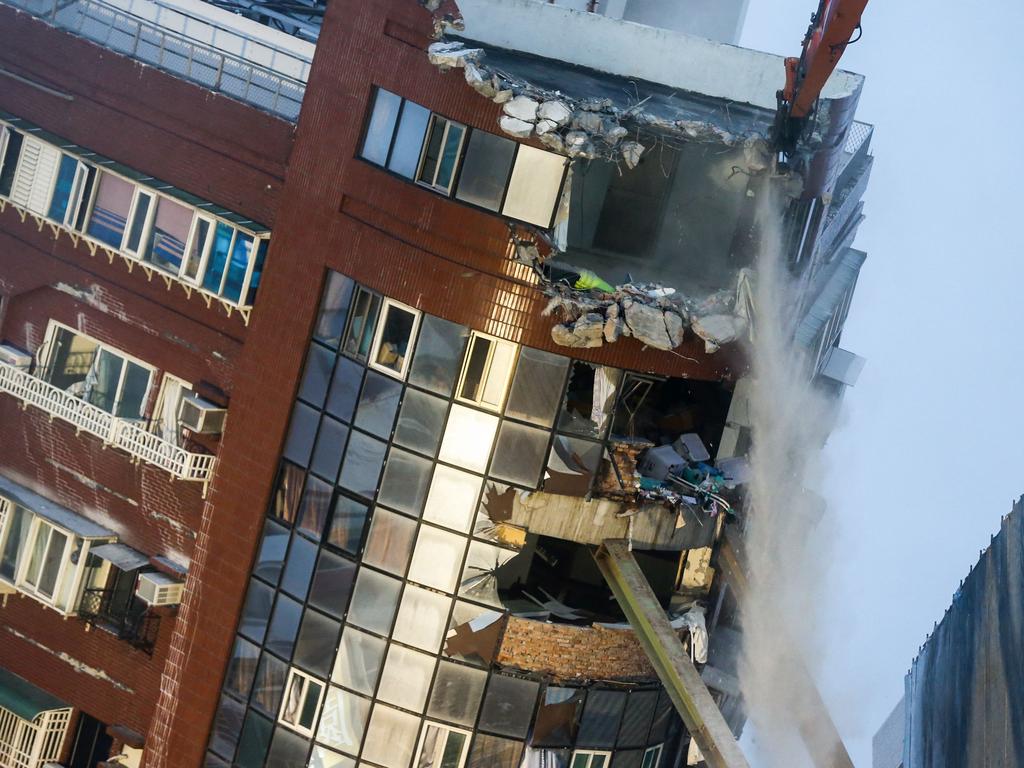 Heavy equipment are being used to demolish the Uranus building, which was damaged in the April 3 earthquake. Picture: AFP