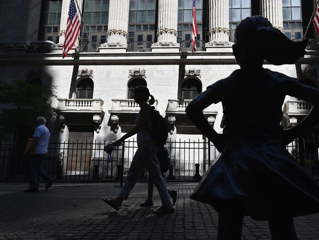 The "Fearless Girl" statue stands in front of the New York Stock Exchange (NYSE) at Wall Street on June 29, 2020 in New York City. - Stock markets on both sides of the Atlantic struggled Monday to rebound from last week's losses as optimism over easing lockdowns was torpedoed by fear over surging coronavirus infections. (Photo by Angela Weiss / AFP)