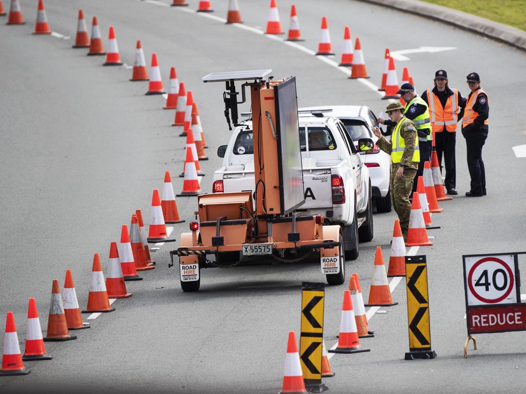 The Premier has hinted that there is a chance of a hard border lockdown if NSW cases head north beyond Newcastle. Police and army at the Queensland border. Picture: Nigel Hallett