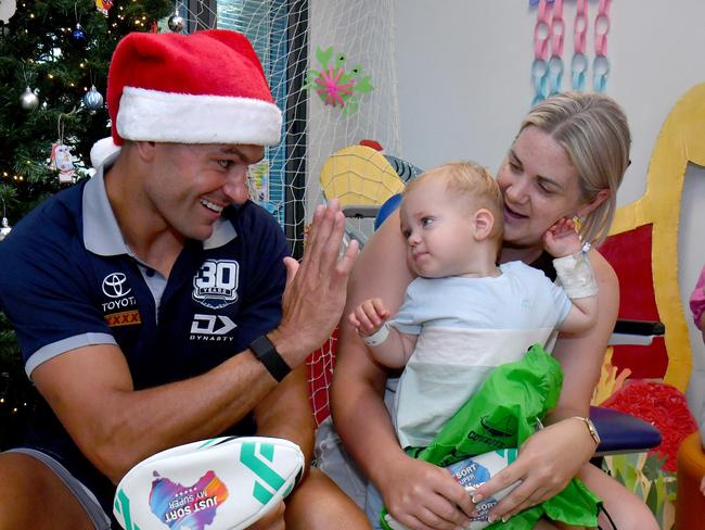 Cowboys Braidon Burns paid a surprise visit to patients, including Christie Ingrey with Leo, 14 months, from Mackay, at the Childrens' Ward at the Townsville University Hospital. Picture: Evan Morgan