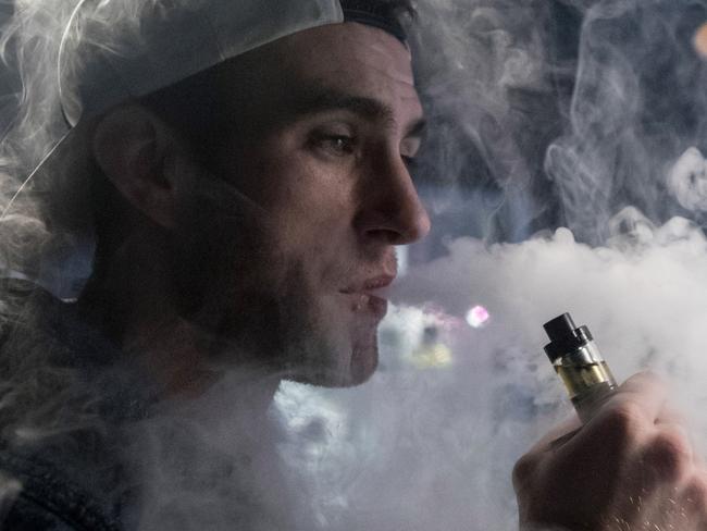 BRISTOL, ENGLAND - DECEMBER 30:  Mitchell Baker who works at the Vapour Place a vaping shop in Bedminster, exhales vapour produced by an e-cigarette on December 30, 2016 in Bristol, England. Recent figures released by the e-cigarette industry has claimed that there as many as 1700 vaping shops across the country, with two new ones opening each day catering for the estimated three million vapers in the UK. The popularity of e-cigarettes has boomed in the last ten years, as it is seen by many as a healthier alternative to traditional cigarettes, however some critics say the devices can carry the same risks as smoking especially as the long term affects are yet to be known.  (Photo by Matt Cardy/Getty Images)