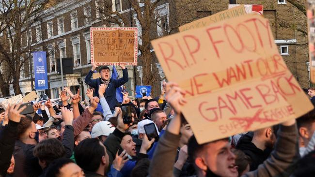 Football supporters demonstrate against the proposed European Super League outside of Stamford Bridge football stadium in London.