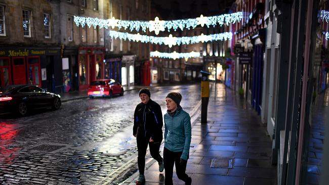 Members of the public are seen in the quiet city centre streets in Edinburgh on December 31 after being urged to bring in the new year at home. Picture: Getty Images