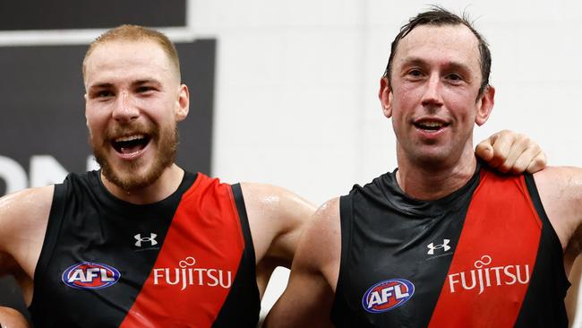 MELBOURNE, AUSTRALIA - MARCH 16: Ben McKay and Todd Goldstein of the Bombers sing the team song during the 2024 AFL Round 01 match between the Essendon Bombers and the Hawthorn Hawks at the Melbourne Cricket Ground on March 16, 2024 in Melbourne, Australia. (Photo by Dylan Burns/AFL Photos via Getty Images)