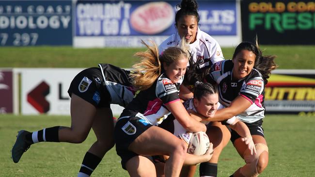 Tweed players combine to bring down Burleigh centre Amber Pilley. Picture: Mike Batterham