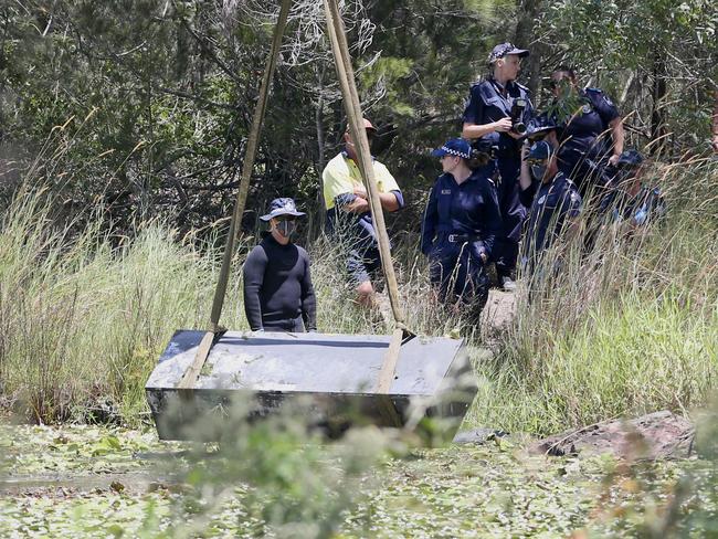 Toolbox murder -  Police retrieve a metal box from a dam near Srubby Creek in Kingston, double murder Logan. Pic Jono Searle.