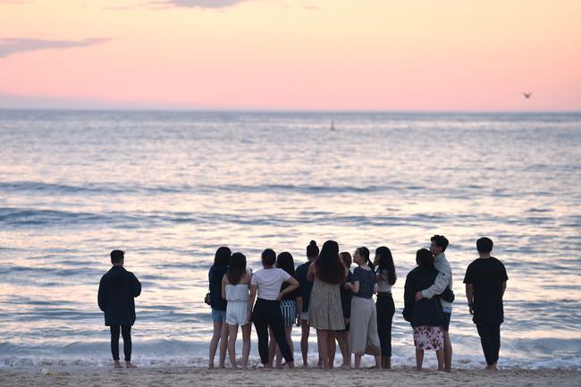 Revellers during the sunrise on New Years Day at Bondi Beach in Sydney. Picture: AAP