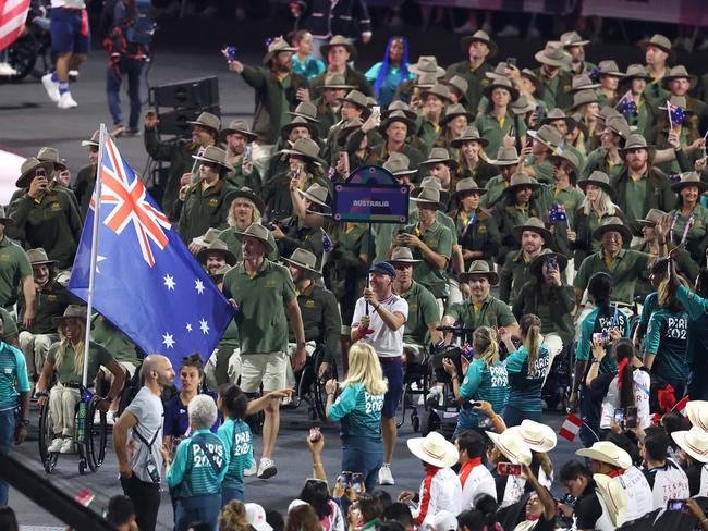 PARIS, FRANCE - AUGUST 28: Madison De Rozario and Brenden Hall, Flag Bearers of Team Australia, hold their national flag as they parade during the opening ceremony of the Paris 2024 Summer Paralympic Games at Place de la Concorde on August 28, 2024 in Paris, France. (Photo by Steph Chambers/Getty Images)