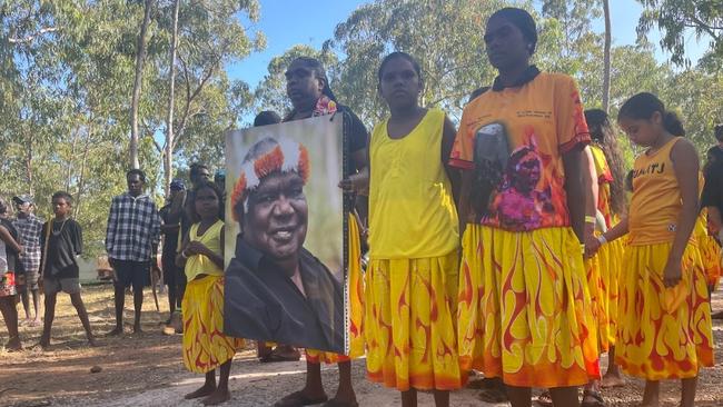 Gumatj clan members hold a photo of late tribal leader Yunupingu at the opening ceremony of the 2023 Garma Festival. Picture: Zizi Averill