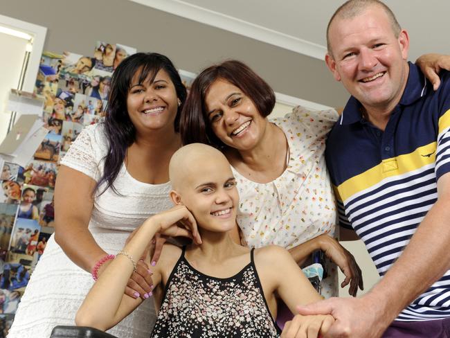 Venessa Harris, then 13, with older sister, Amber, and her parents Karen Monaghan and Kelly Harris. Photo: Paul Guy