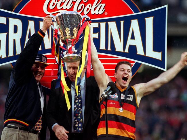 Malcolm Blight and Mark Bickley holding the AFL trophy after winning the 1997 grand final against St Kilda.