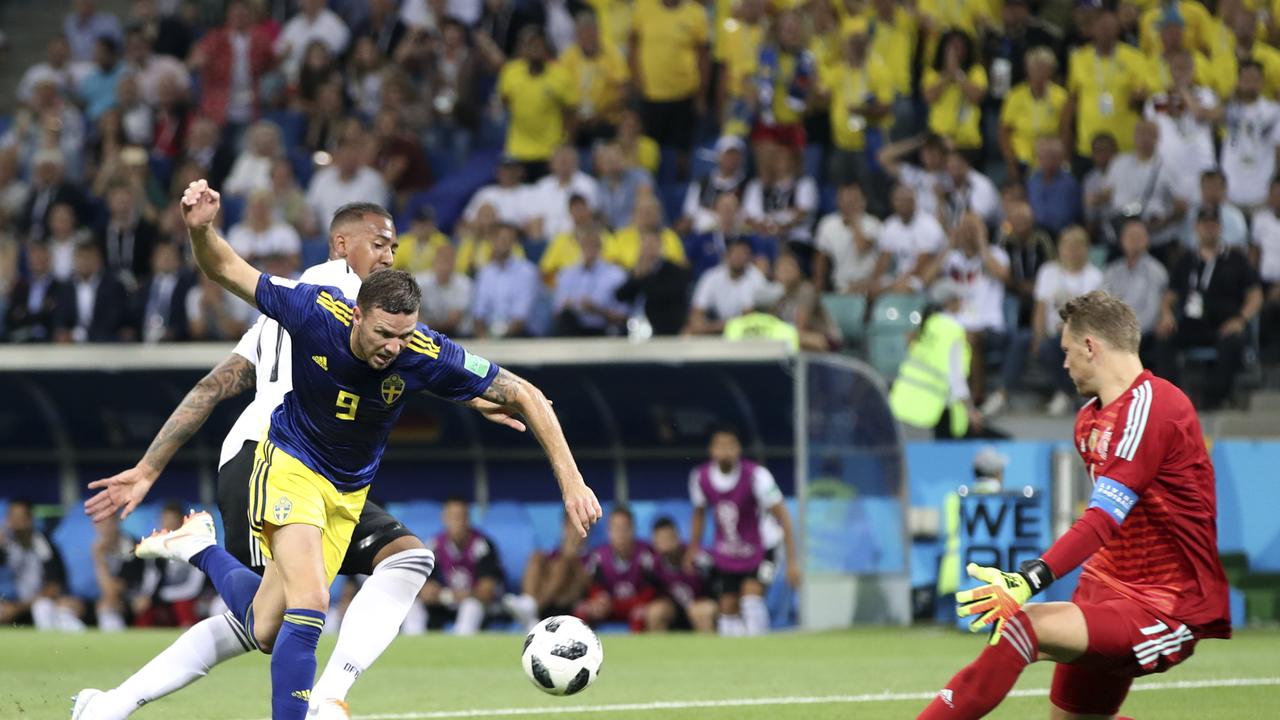 Germany goalkeeper Manuel Neuer, right, makes a save in front of Sweden's Marcus Berg