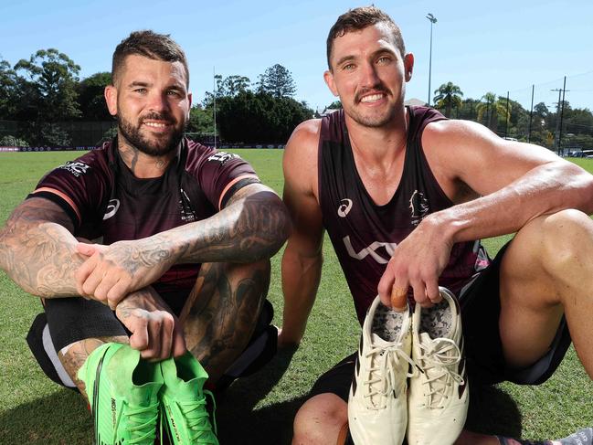 Adam Reynolds and Corey Oates with their boots that are to auctioned for charity, Brisbane Broncos training, Red Hill. Picture: Liam Kidston