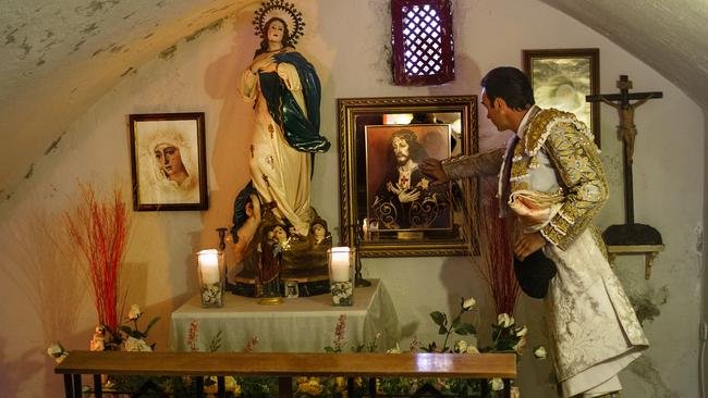 Spanish bullfighter Enrique Ponce prays inside the bullring's chapel before a bullfight. Picture: Daniel Ochoa de Olza