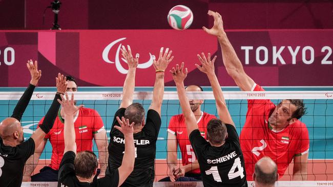 Mehrzad (far right) hits the ball during a match at the Tokyo Paralympic Games. (Photo by Yasuyoshi CHIBA / AFP)