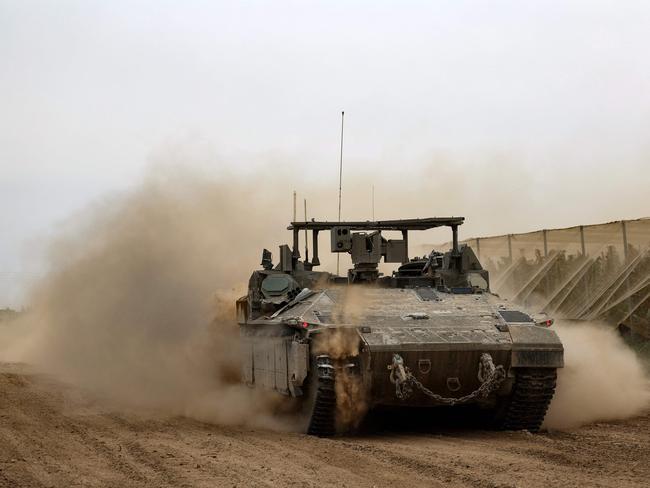 An Israeli tank rolls along the border with the Gaza Strip on February 23, 2024, amid ongoing battles between Israel and the Palestinian militant group Hamas. (Photo by JACK GUEZ / AFP)