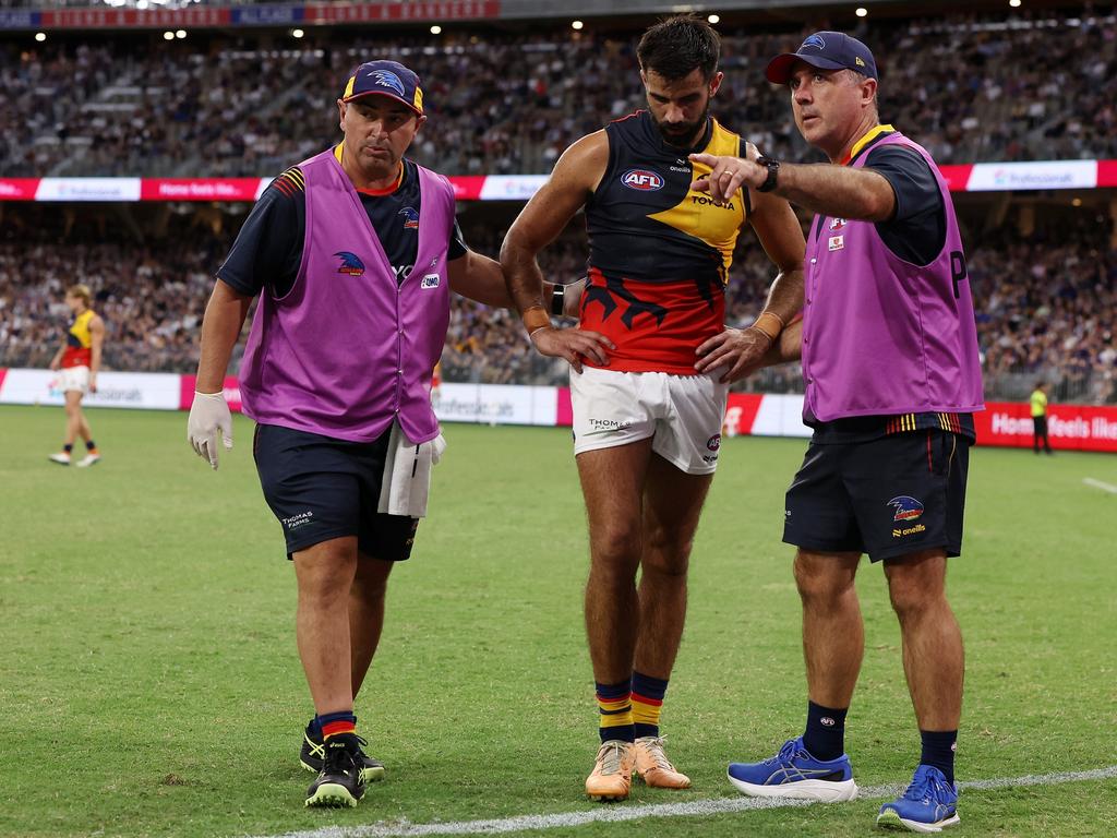 Wayne Milera of the Crows is assisted off the field injured. (Photo by Will Russell/AFL Photos via Getty Images)