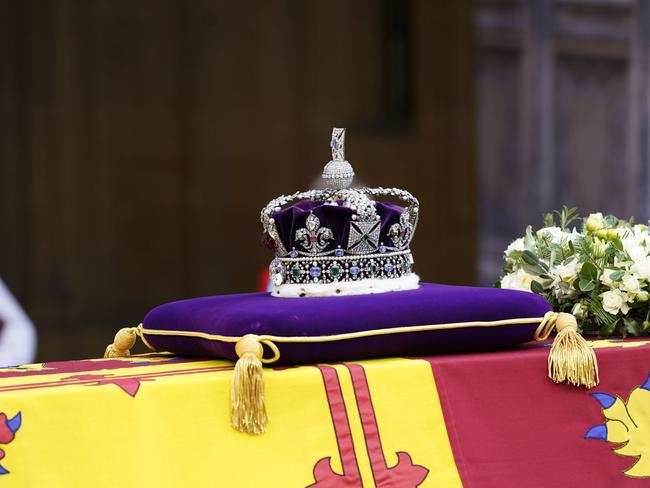 The Queen’s coffin, adorned with a Royal Standard and the Imperial State Crown, arrives at Westminster Hall where it will lie in state. Picture: Getty Images