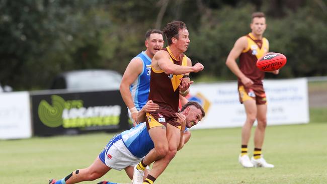 Drysdale's Hamish Paynter (42) handballs under pressure from Barwon Heads Archie Hildebrandt (32). Drysdale v Barwon Heads senior BFL football. Picture: Alan Barber