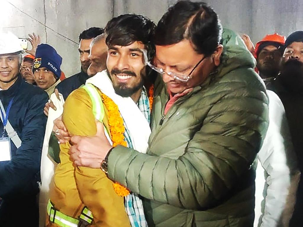 Chief minister of Uttarakhand Pushkar Singh Dhami (R) embracing a contruction worker following his rescue from inside the under construction Silkyara tunnel. Picture: Department of Information and Public Relation (DIPR) Uttarakhand / AFP