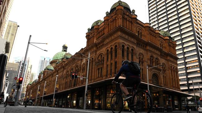 A cyclist makes his way through a near-empty George St in the Sydney CBD on Tuesday. Picture: AFP