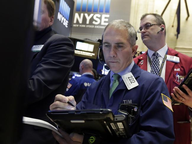 Trader Timothy Nick, center, works on the floor of the New York Stock Exchange, Tuesday, Jan. 19, 2016. U.S. stocks are opening higher, led by gains in banks and technology companies. (AP Photo/Richard Drew)