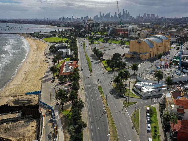 The streets of Melbourne looking empty, yet other times still busy, as we enter our first day of  a week-long lockdown.  St Kilda beach with Luna Park on the left. Picture: Alex Coppel.