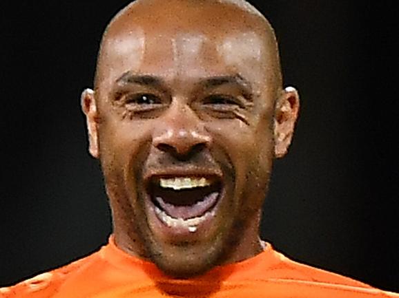 HOBART, AUSTRALIA - DECEMBER 14: Tymal Mills of the Scorchers celebrates the wicket of Caleb Jewell of the Hurricanes during the Men's Big Bash League match between the Hobart Hurricanes and the Perth Scorchers at Blundstone Arena, on December 14, 2021, in Hobart, Australia. (Photo by Steve Bell/Getty Images)