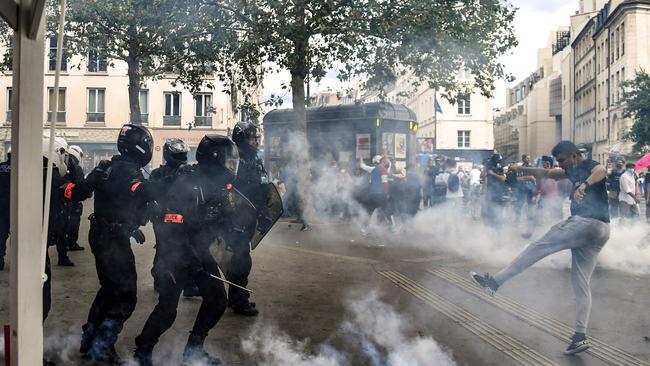 Demonstrators clash with police brigades in Paris during a national day of protest against French legislation making a Covid-19 health pass compulsory to visit a cafe, board a plane or travel on an intercity train. Picture: AFP