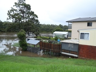 The water is creeping up on houses along Henry Lawson Drive in Panania. Picture: John Grainger