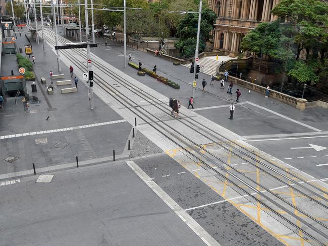 A near empty intersection is seen in front of Town Hall Sydney last month. Picture: Bianca De Marchi