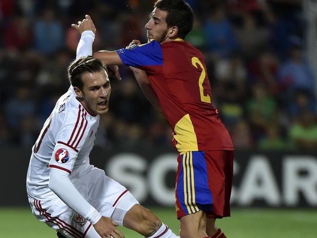 Andorra defender Cristian Martinez (R) vies with Wales forward Aaron Ramsey during the Euro 2016 qualifying round football match Andorra vs Wales on September 9, 2014 at the Municipal Stadium in Andorra. AFP PHOTO / PASCAL PAVANI