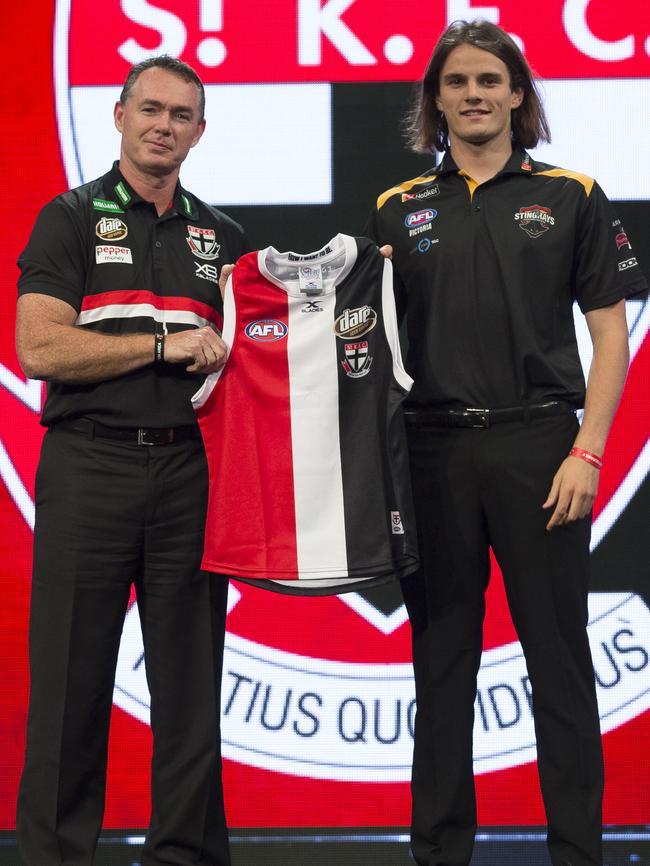 Hunter Clark is presented his guernsey by coach Alan Richardson.