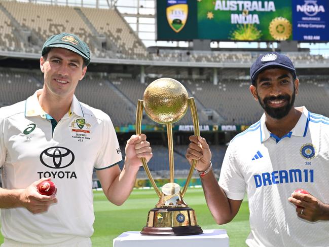 Australiaâs captain Pat Cummins (L) and Indiaâs captain Jasprit Bumrah pose with the trophy at Optus Stadium in Perth on November 21, 2024, ahead of the first cricket Test between Australia and India. (Photo by SAEED KHAN / AFP) / -- IMAGE RESTRICTED TO EDITORIAL USE - STRICTLY NO COMMERCIAL USE --