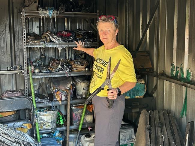 Karama Community Garden committee member Justine Glover looks at the wreckage of the group's shed after a wayward firework burned it down on Territory Day, 2024.