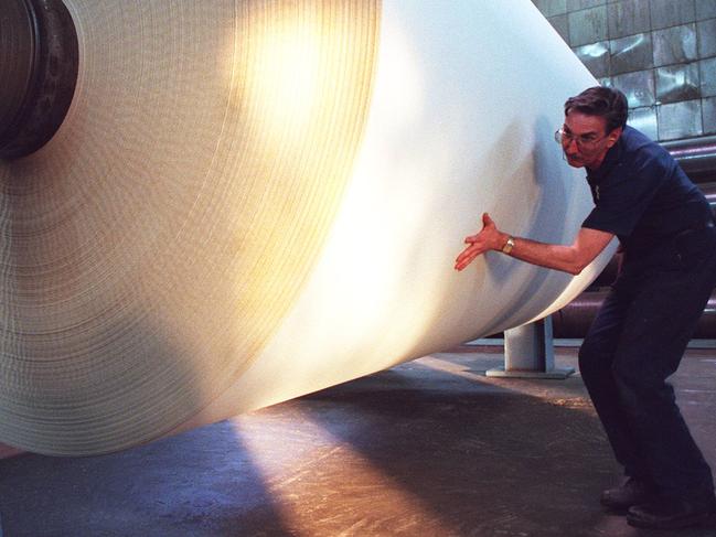 Workers moving roll of Amcor's Reflex branded copy paper at its mill in Victorian town of Maryvale.