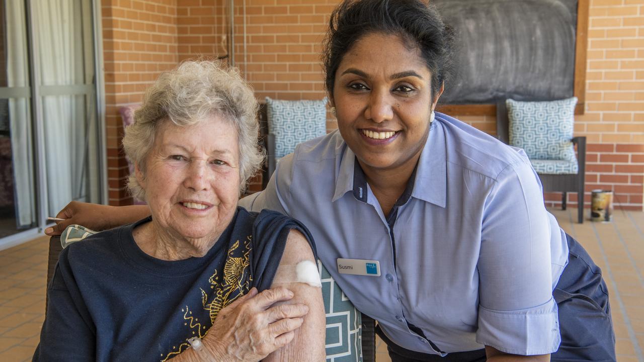 PFIZER JAB: Bupa Glenvale manager Susmi John (right) and resident Jane Heron were all smiles during the rollout of the Pfizer vaccine at the facility yesterday. Picture: Nev Madsen