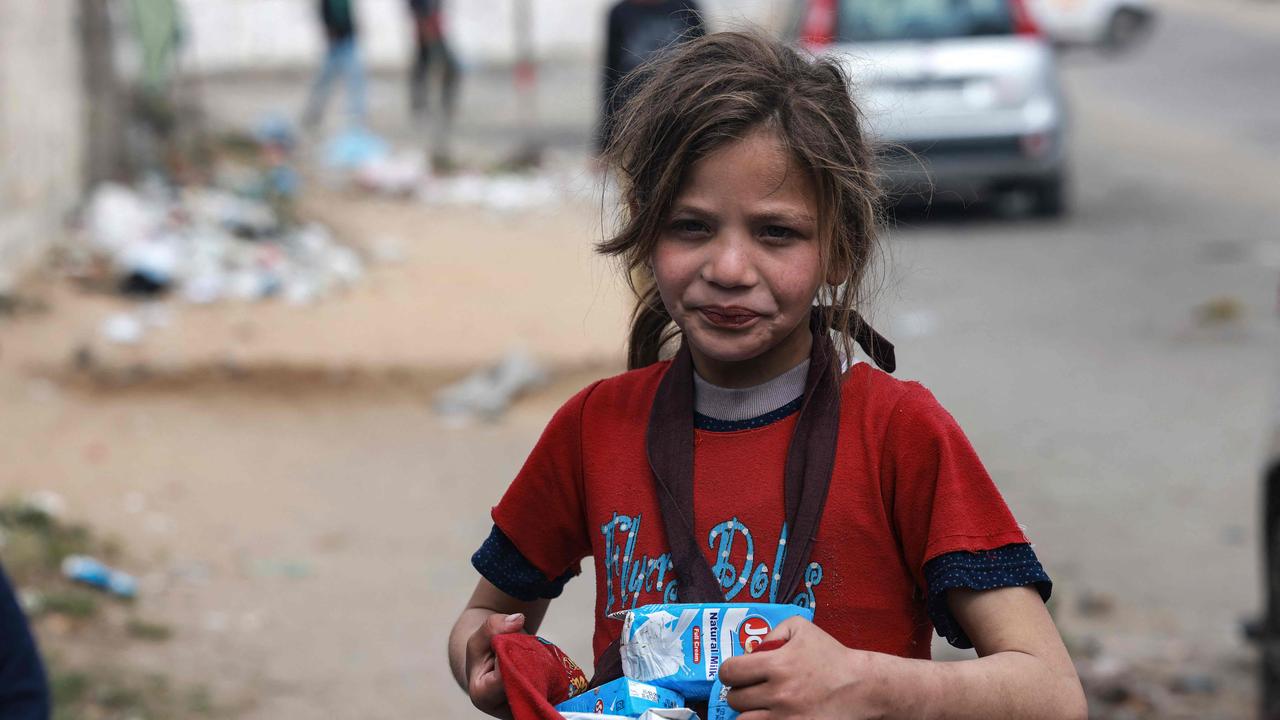 A Palestinian child sells boxes of milk in a market in Ramadan, in Rafah in the southern Gaza Strip. Picture: Mohammed Abed/AFP