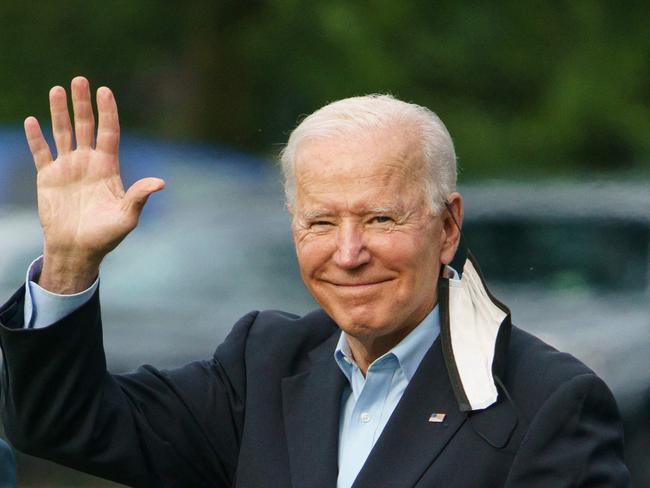 US President Joe Biden waves as he and First Lady Jill Biden make their way to board Marine One before departing from The White House ahead of his foreign tour.