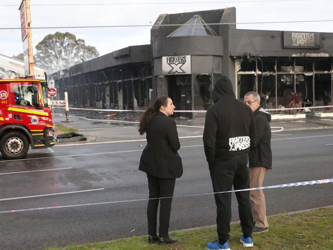 A person wearing a Fighter Xpress jumper assesses the damage. Picture: David Crosling