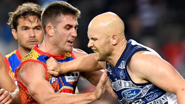 Gary Ablett (right) of the Cats is seen scuffling with Anthony Miles (left) of the Suns during the Round 10 AFL match between the Gold Coast Suns and the Geelong Cats at Metricon Stadium on the Gold Coast, Saturday, May 25, 2019.  (AAP Image/Darren England) NO ARCHIVING, EDITORIAL USE ONLY