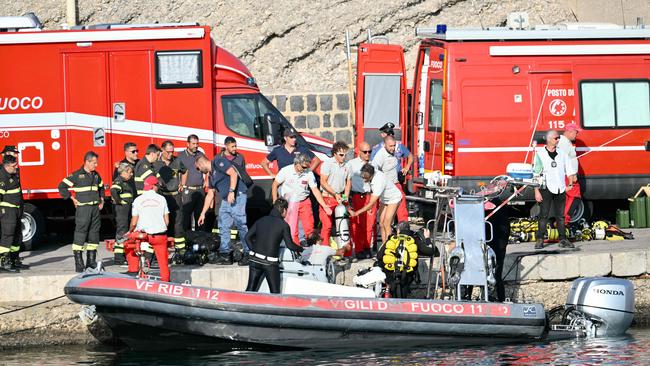 Divers return to port at Porticello near Palermo, as the search for the missing people continue. Picture: AFP.