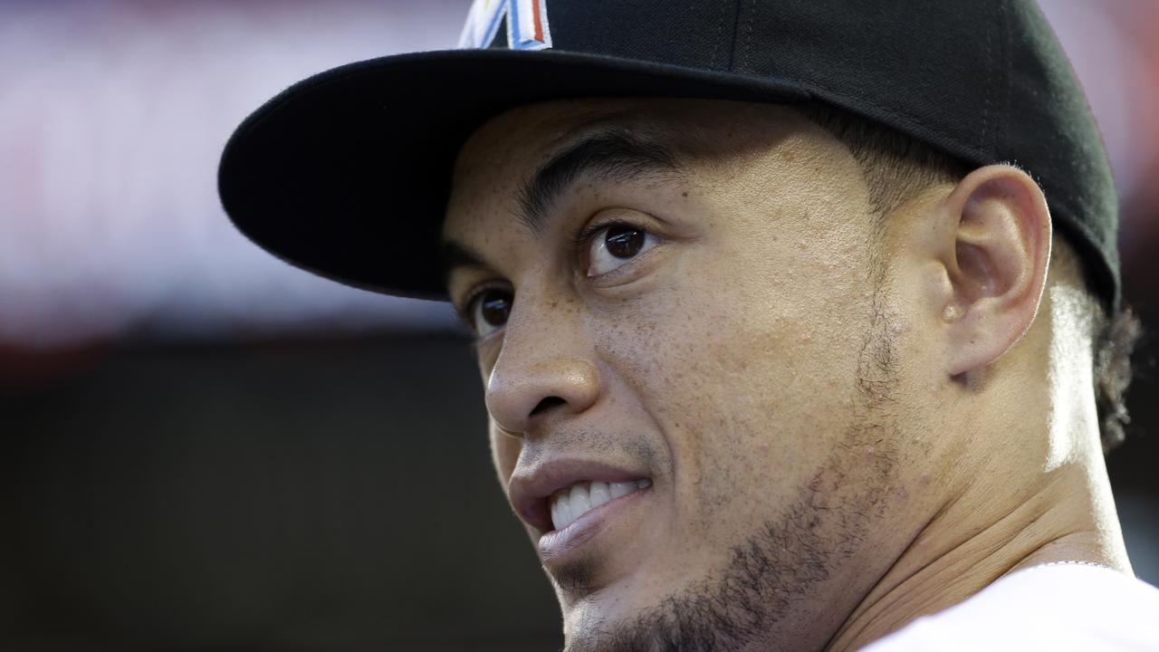 FILE - This is a May 5, 2014, file photo showing Miami Marlins right fielder Giancarlo Stanton in the dugout before a baseball game against the New York Mets in Miami. A person familiar with the negotiations says Marlins slugger Giancarlo Stanton has agreed to terms with the team on a $325 million, 13-year contract. It's the most lucrative deal for an American athlete. The person spoke to The Associated Press on condition of anonymity because the Marlins hadn't confirmed the agreement Monday, Nov. 17, 2014. (AP Photo/Alan Diaz, File)