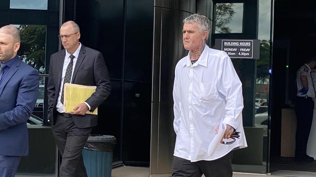 Travis John Chisholm (white shirt) leaves court in Southport.