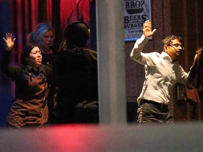 Hostages run to safety during the cafe siege. Picture: AAP