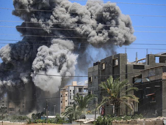 Smoke rises from a building hit by an Israeli strike in Nuseirat in the central Gaza Strip on July 20, 2024, amid the ongoing conflict between Israel and the Palestinian militant group Hamas. (Photo by Eyad BABA / AFP)