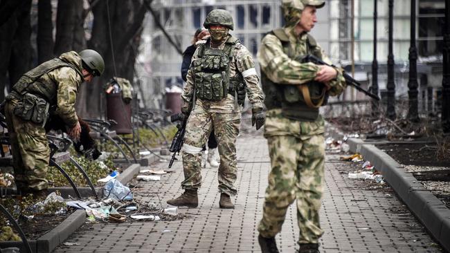 Russian soldiers walks along a street in Mariupol. Picture: AFP