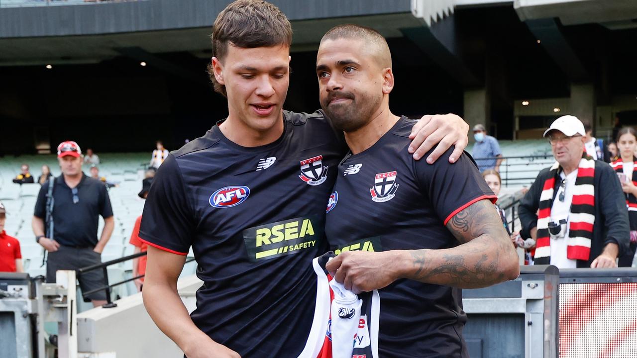 Debutant Marcus Windhager is presented with his jumper by Bradley Hill. Picture: Michael Willson