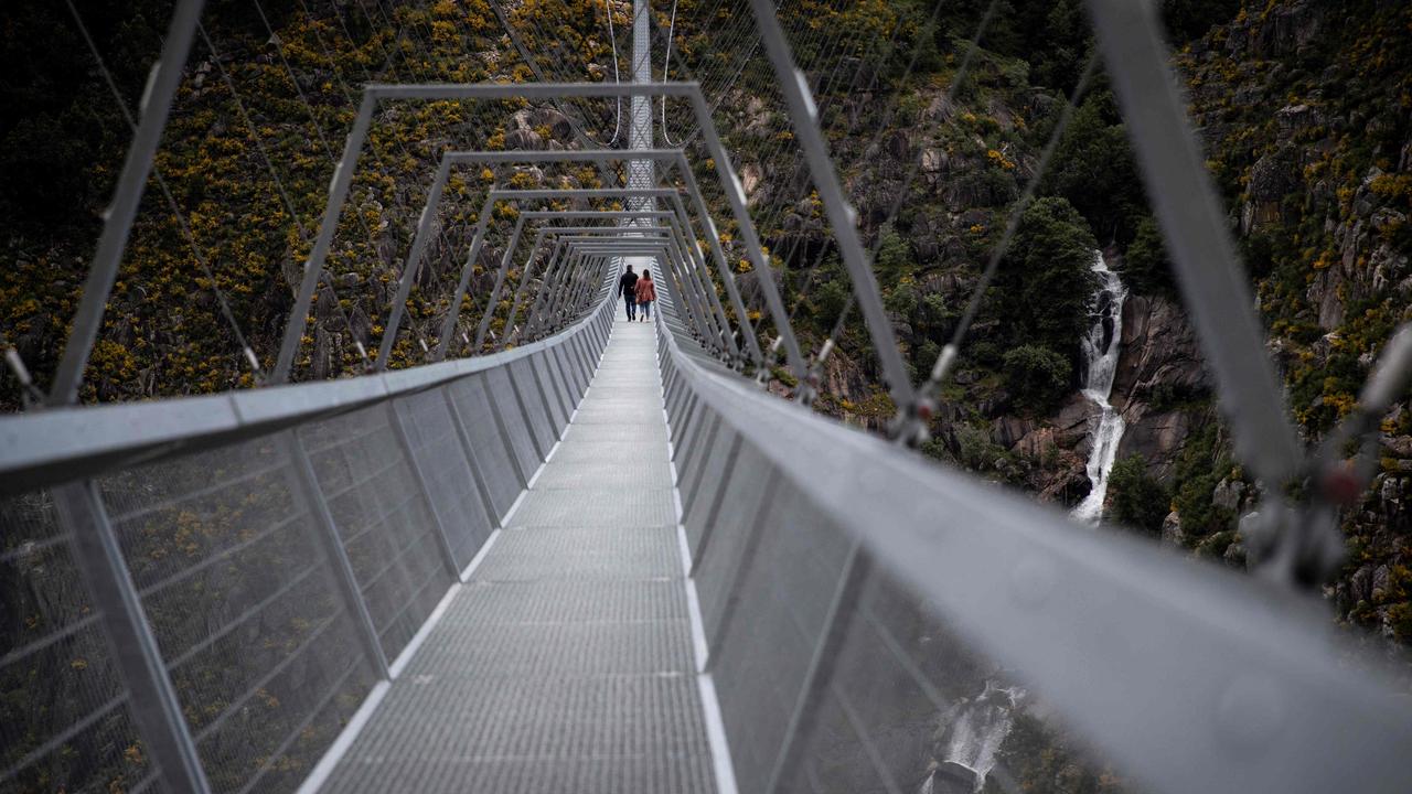 People cross the world's longest pedestrian suspension bridge in Arouca in northern Portugal. Picture: Carlos Costa/AFP
