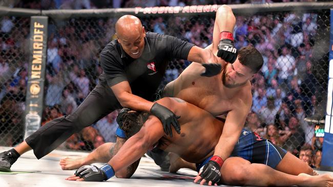 The official gets between Greg Hardy and Tai Tuivasa in the first round in their heavyweight bout during UFC 264. Picture: Stacy Revere/Getty